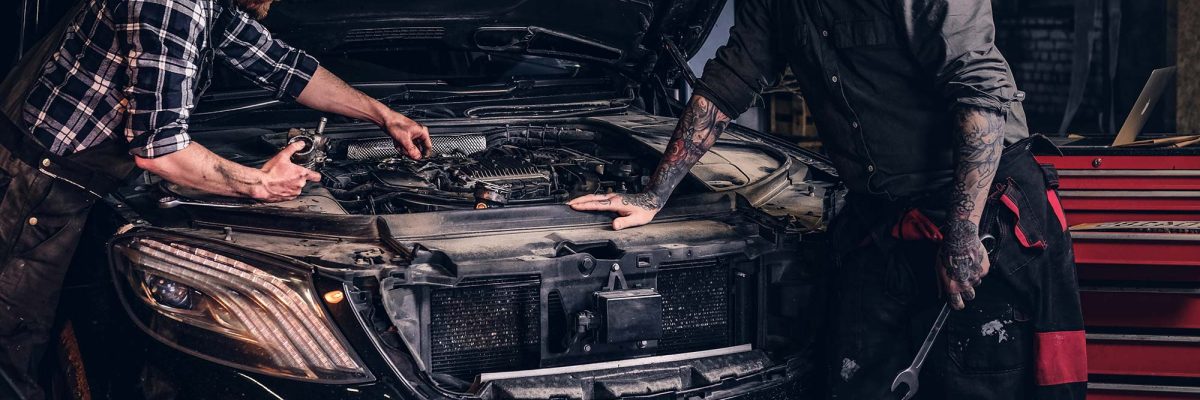 two-bearded-auto-mechanic-working-in-repair-garage-small